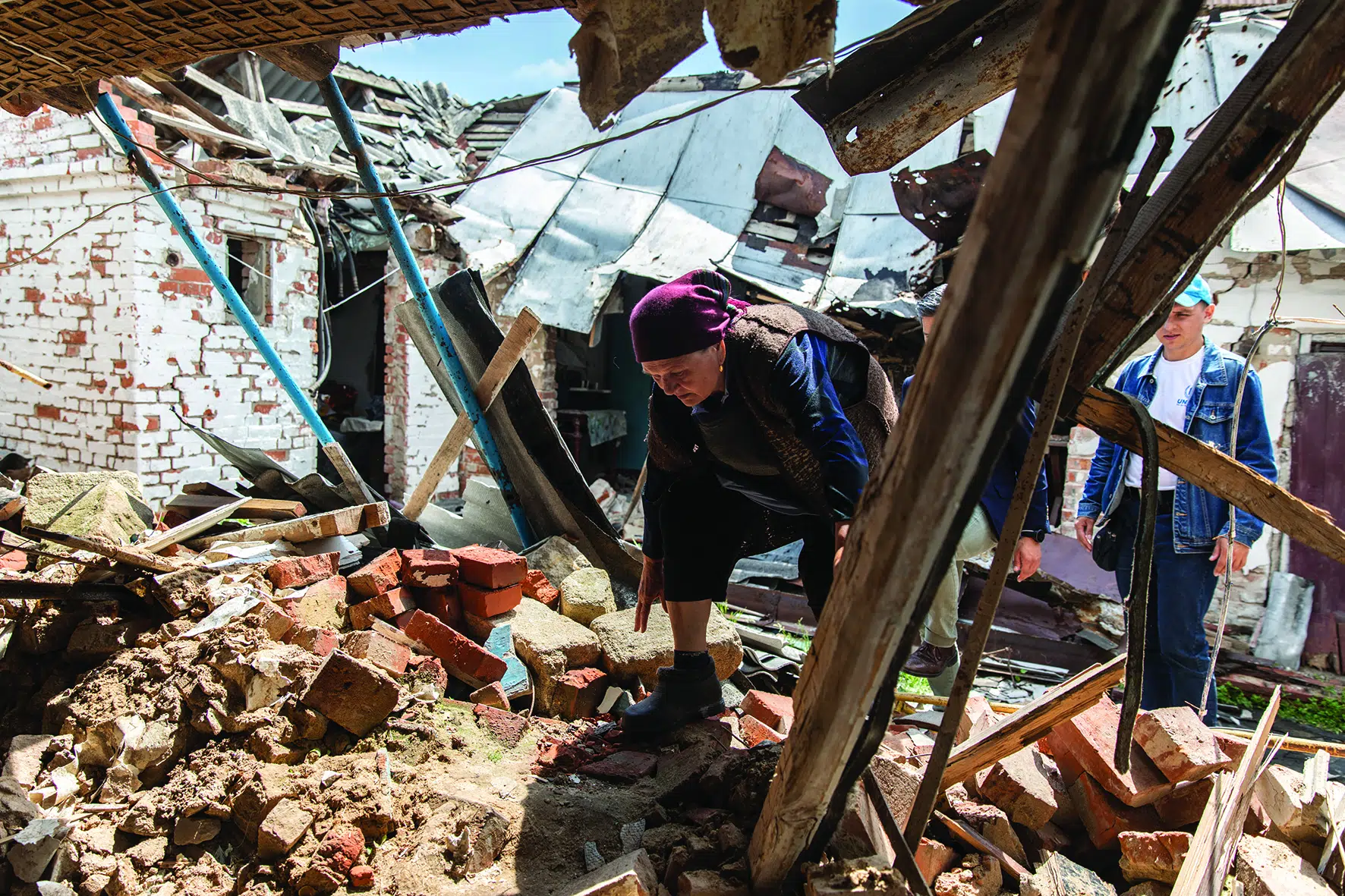 Woman walks through rubble