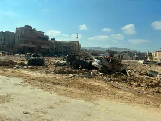 Wrecked vehicles lie washed up on a patch of waste ground after deadly floods hit the city of Derna in eastern Libya.

© UNHCR/Ahmed Al Houdiri