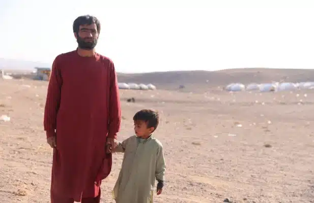 Zahir and his son Murtaza near the tent where they live after their house was destroyed in the earthquake that struck Afghanistan's Herat province on 7 October. © UNHCR/Samand Ibrahimi