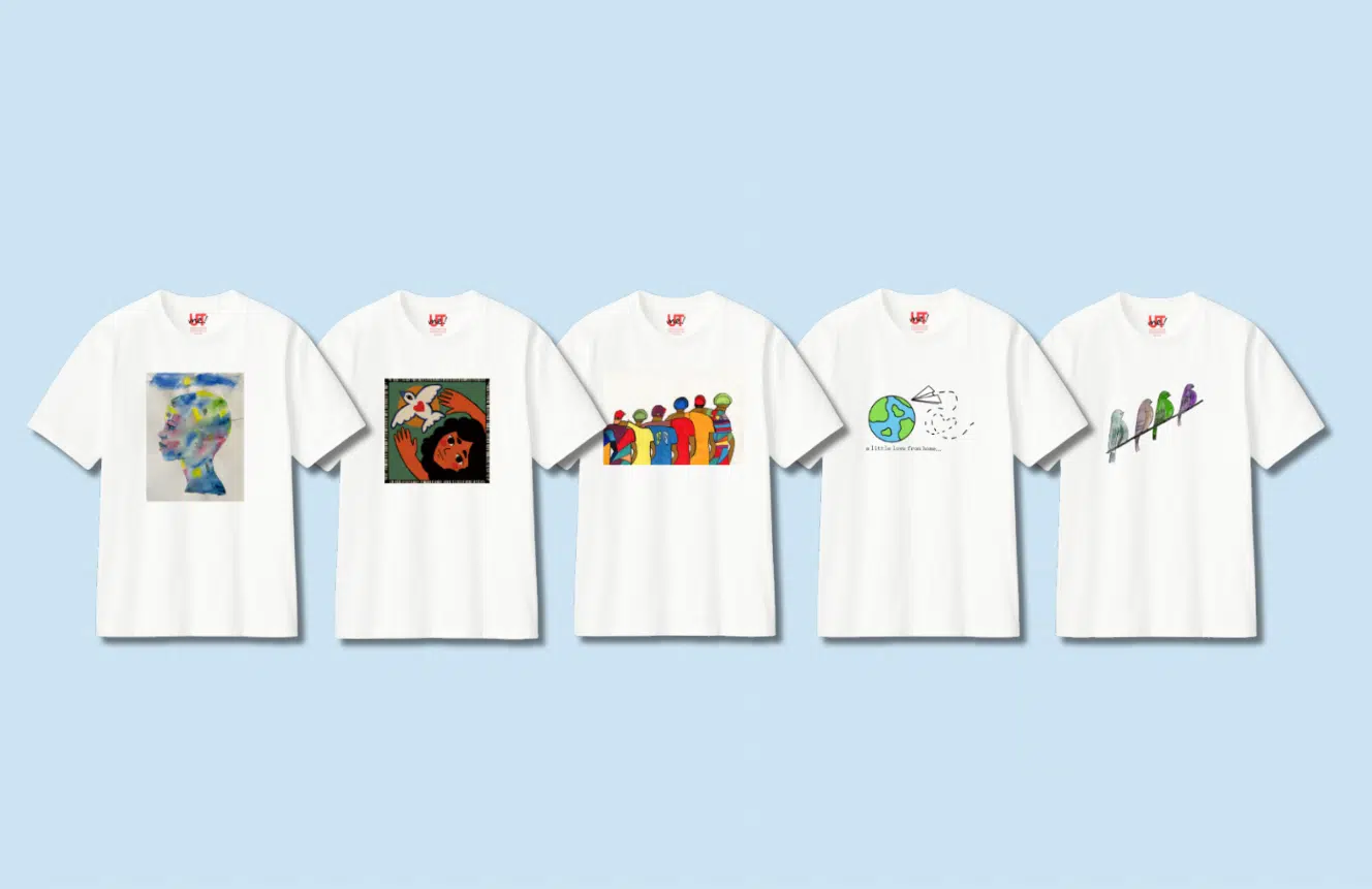 white t-shirts with different art designs on them in a line in front of a light blue background 