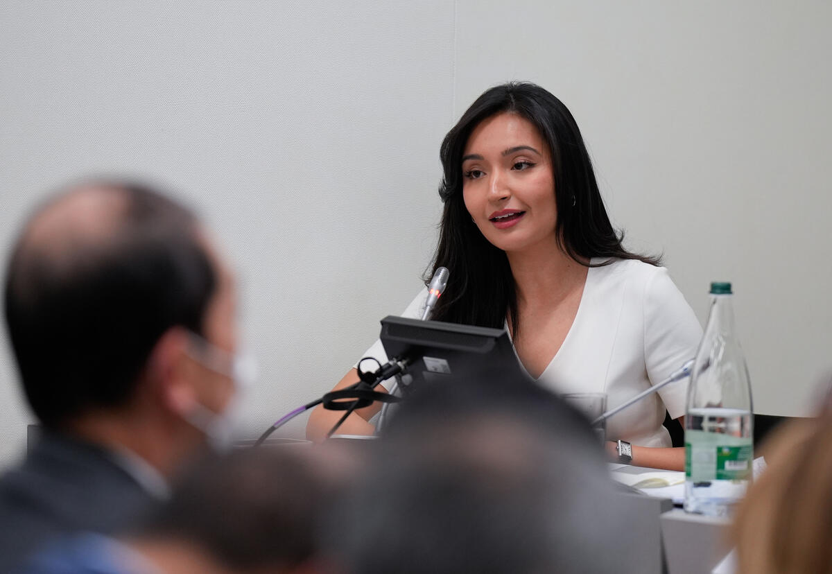 A woman speaking at a desk