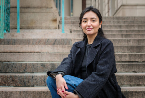 A close-up of a woman sitting on stone steps