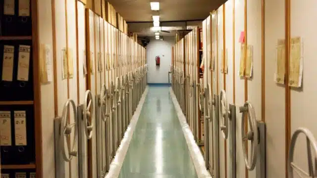 Hallway with book shelves on both sides of it. The bookshelves have books on it.