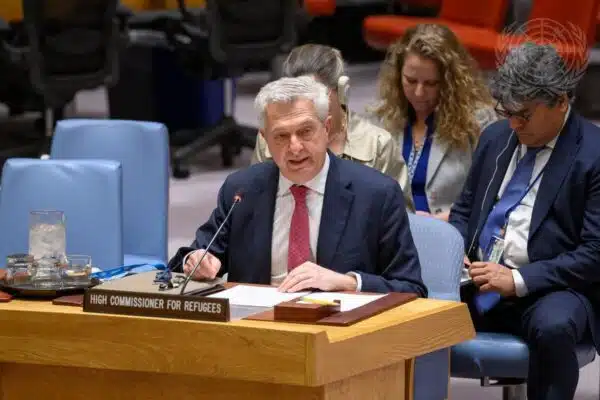 UN High Commissioner for Refugees Filippo Grandi is seen sitting at a wood-coloured conference desk and reading from his notes addressing members of the UN Security Council in New York.