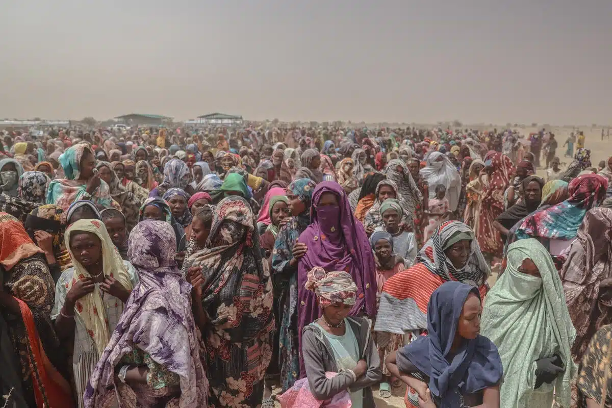 Thousands of Sudanese refugees, mostly women and children, are seen in the photo.