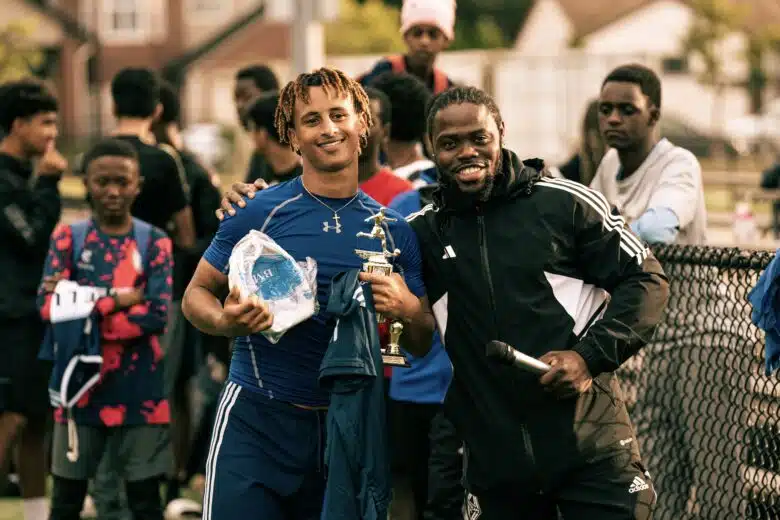 Dacious Richardson with his arm around a player to his left.