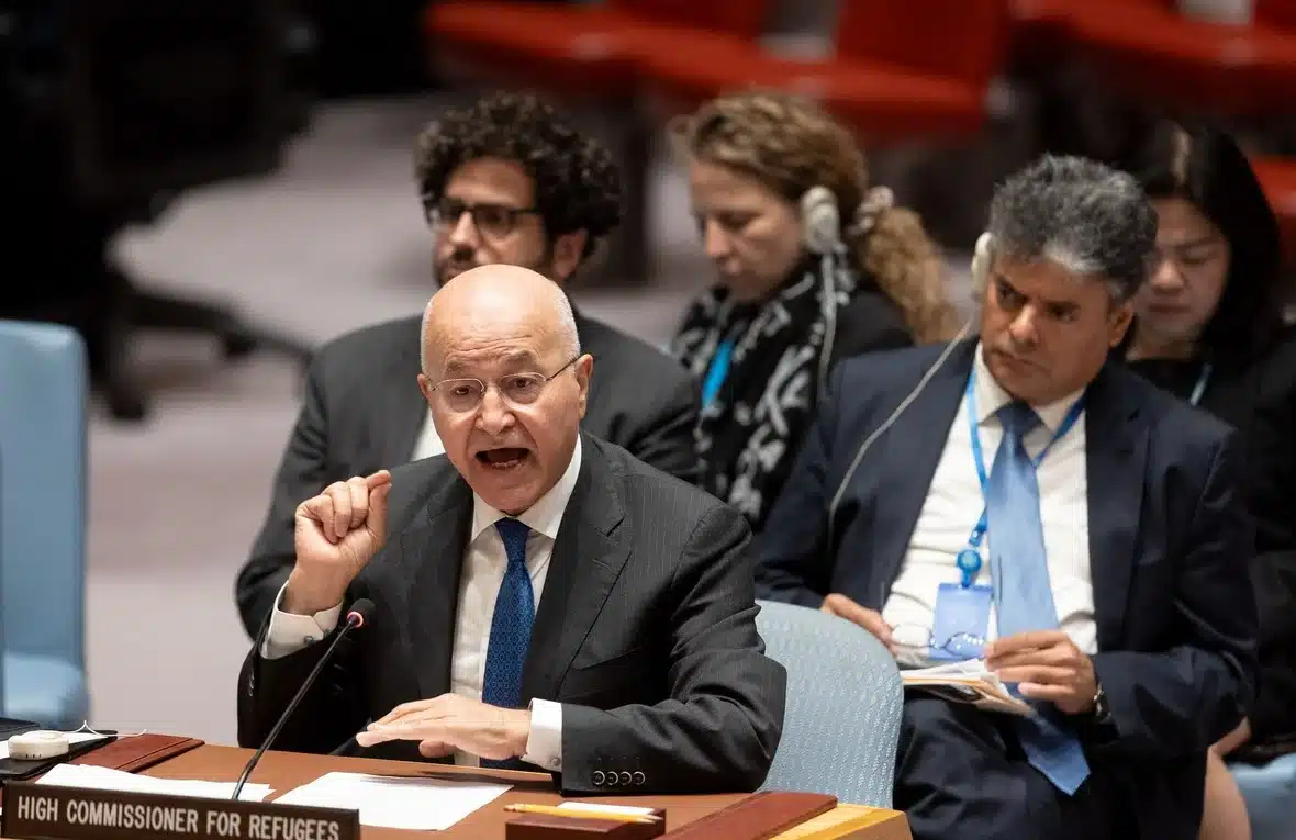 UN High Commissioner for Refugees Barham Salih has raised his hand while sitting at a desk while he delivers a speech to the United Nations Security Council in New York.