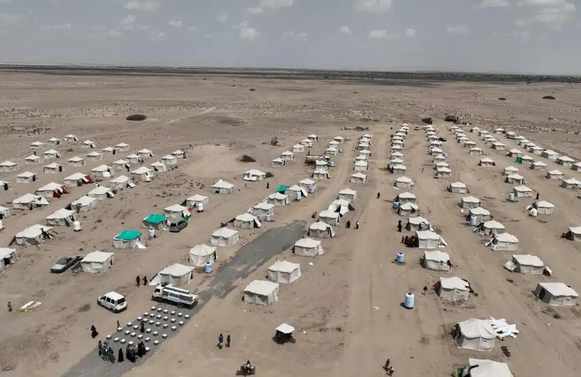 Rows upon rows of white tents lined in straight lines are visible in this aerial view of Al-Firdaws displacement site in Yemen's Aden Governorate.
